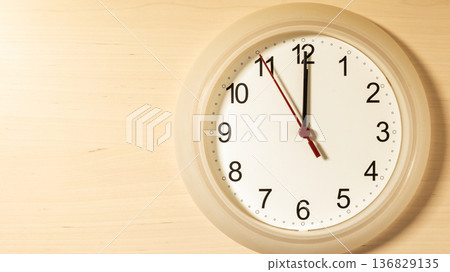 Clock ticking showing twelve hours 136829135