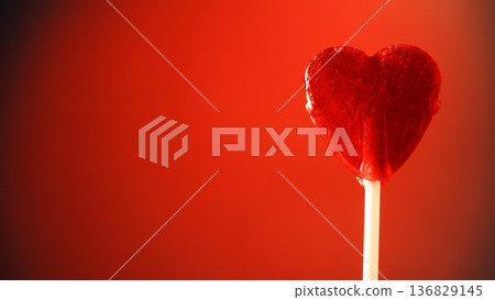 Candy heart against red background Candy heart against red background 136829145