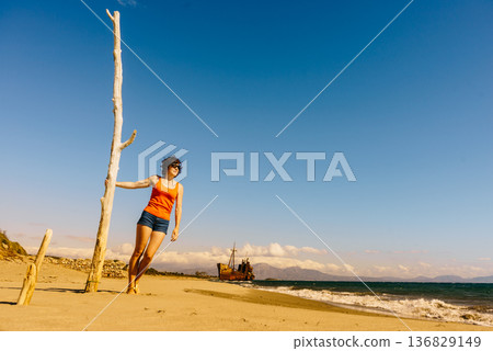 Tourist woman on beach enjoying vacation Tourist woman on beach enjoying vacation 136829149