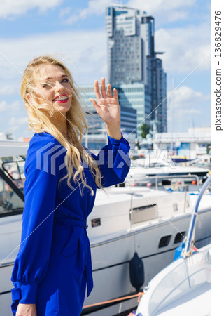 Fashion model wearing blue jumpsuit Fashion model wearing blue jumpsuit 136829476