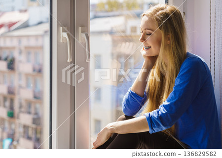 Girl on window enjoying sunny day 136829582