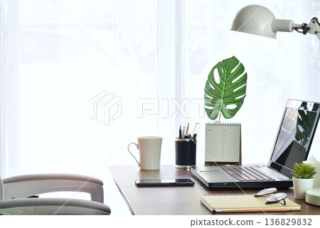 Minimal style modern home office There are bright and comfortable. decorated with wooden table white chair There are curtain and white windows background 136829832