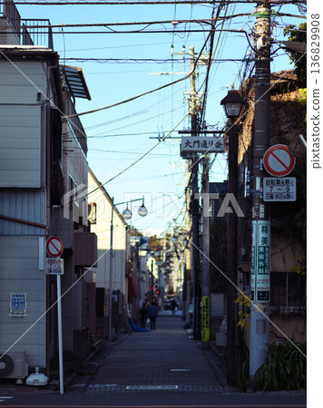 Under the blue sky, an alleyway scene of Daimon-dori Street in Ichikawa City leading to Kobo-ji Temple 136829908