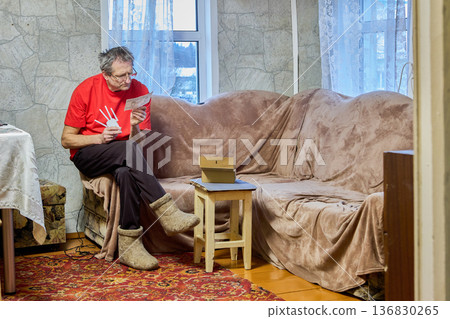 Middle-aged man is installing repeater to strengthen Wi-Fi signal in rural house. Middle-aged man is installing repeater to strengthen Wi-Fi signal in rural house. 136830265