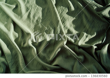 Sage green fabric creating texture and folds 136830560