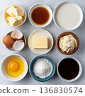 Baking ingredients flat lay on white background with eggs butter flour sugar and honey 136830574