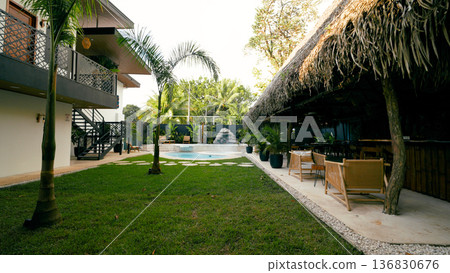Tropical resort backyard with swimming pool and lounge area Tropical resort backyard with swimming pool and lounge area 136830676
