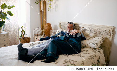 Senior couple hugging in bed feeling comfortable and relaxed 136830753