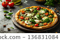 Artistic flat lay of green matcha pizza with red tomatoes contrasting against deep dark background, trendy restaurant menu concept 136831084