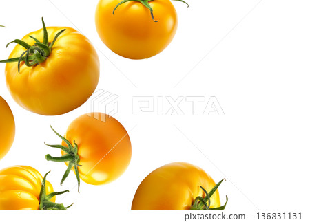 Fresh yellow tomatoes of various shapes and sizes floating against a white background, food and health concept 136831131