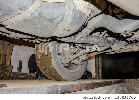 Rear wheel of the car with the elements of the suspension system. Car service Rear wheel of the car with the elements of the suspension system. Car service 136831700