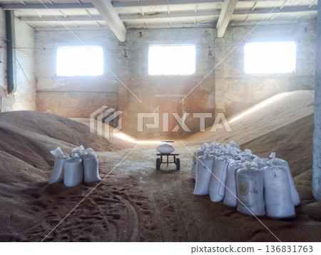 Heap of grains of barley and wheat in stock Heap of grains of barley and wheat in stock 136831763