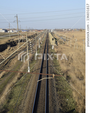 Plot railway. Top view on the rails. High-voltage power lines for electric trains Plot railway. Top view on the rails. High-voltage power lines for electric trains 136831817