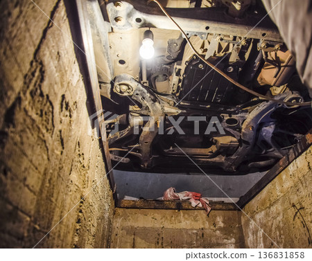 View of the car from below. Autoservice center. Car maintenance. View of the car from below. Autoservice center. Car maintenance. 136831858