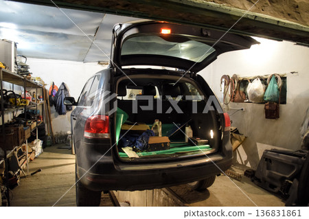 The Volkswagen car is in the garage with an open trunk. 136831861