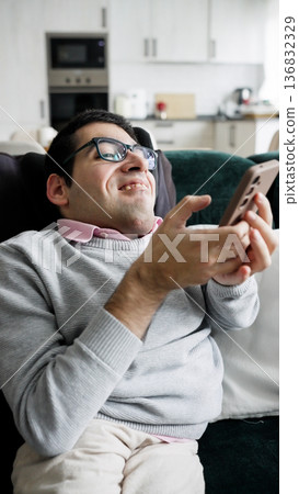 Adult man enjoying digital lifestyle with smartphone at home Adult man enjoying digital lifestyle with smartphone at home 136832329