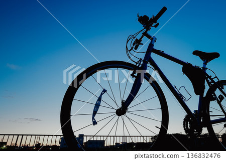Sunset sky and the silhouette of a cross bike Sunset sky and the silhouette of a cross bike 136832476