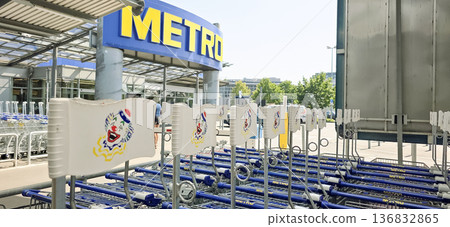 Berlin, Germany - June 21, 2025: Metro supermarket entrance with shopping carts lined up outside Berlin, Germany - June 21, 2025: Metro supermarket entrance with shopping carts lined up outside 136832865