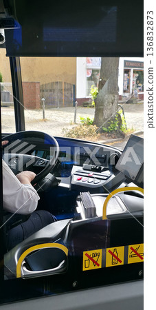 Berlin, Germany - August 07, 2025: Bus driver operating vehicle with modern dashboard and controls Berlin, Germany - August 07, 2025: Bus driver operating vehicle with modern dashboard and controls 136832873