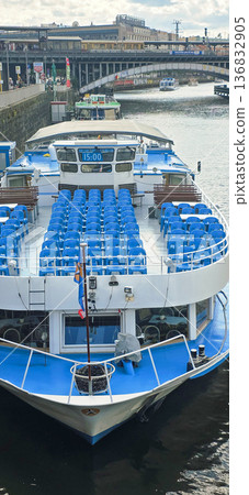 Berlin, Germany - September 03, 2025: Blue seating on river cruise boat docked at city waterfront location 136832905