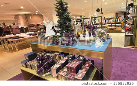 Berlin, Germany - September 19, 2025: Holiday display with purple decorations and Christmas tree in retail store Berlin, Germany - September 19, 2025: Holiday display with purple decorations and Christmas tree in retail store 136832926