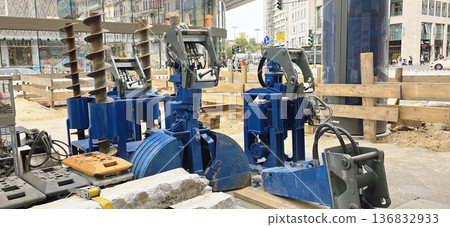 Berlin, Germany - September 22, 2025: Construction machinery with blue hydraulic equipment at urban site Berlin, Germany - September 22, 2025: Construction machinery with blue hydraulic equipment at urban site 136832933