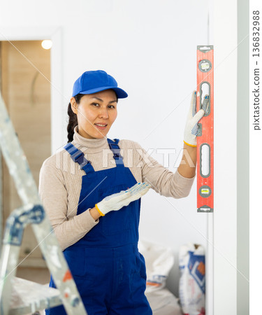 Female repairer setting level to wall Female repairer setting level to wall 136832988