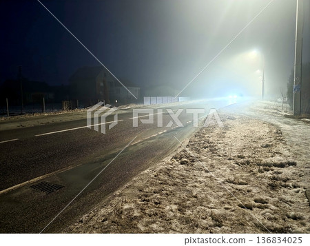 Night Time on a Snow Covered Road With Fog and Distant Car Headlights in the Scene Night Time on a Snow Covered Road With Fog and Distant Car Headlights in the Scene 136834025