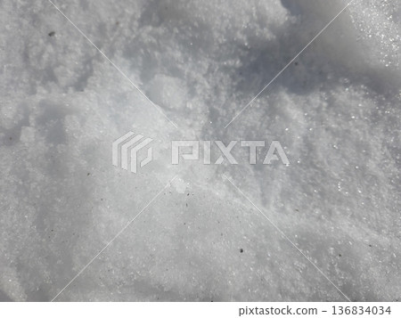 Snow Texture Shows Details of Winter Landscape Under Bright Sunlight 136834034