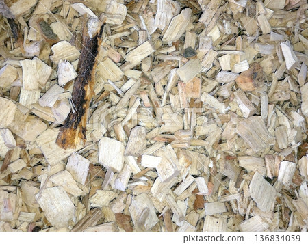 Wood Chips Scattered on a Surface in a Natural Setting During Daylight Hours 136834059