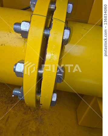 Close View of Yellow Gas Pipe With Flange Connection and Bolts on Construction Site Close View of Yellow Gas Pipe With Flange Connection and Bolts on Construction Site 136834060
