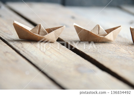 Paper boats on a vintage background. Paper boats on a vintage background. 136834492