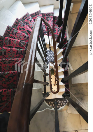 Vintage carpet on a swirling staircase in an apartment in Paris 136834698