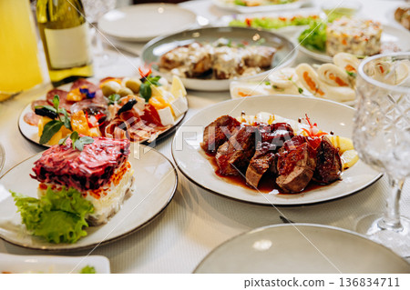 Grilled meat with sauce served on elegant festive restaurant dinner table Grilled meat with sauce served on elegant festive restaurant dinner table 136834711