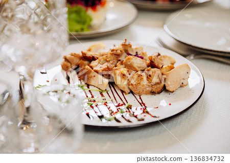 Grilled chicken fillet pieces served with sauce and gourmet restaurant presentation Grilled chicken fillet pieces served with sauce and gourmet restaurant presentation 136834732