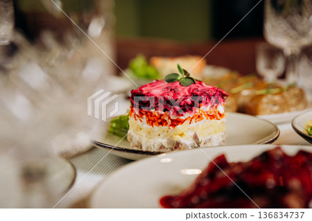 Layered herring Shuba salad with beetroot and mayonnaise on festive table 136834737