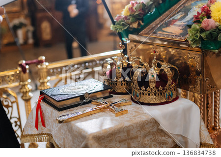 Orthodox wedding crowns and cross on altar during traditional church marriage ceremony 136834738