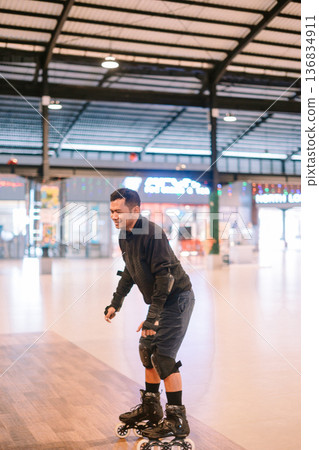 Happy Man Inline Skating Indoors with Protective Gear Happy Man Inline Skating Indoors with Protective Gear 136834911