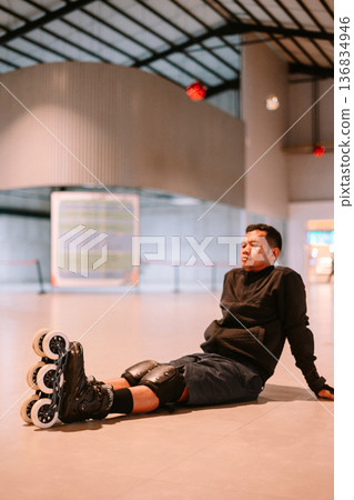 Inline Skater Resting on Floor After Sport Session 136834946