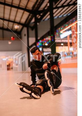 Young Man Resting After Active Inline Skating Session 136834947