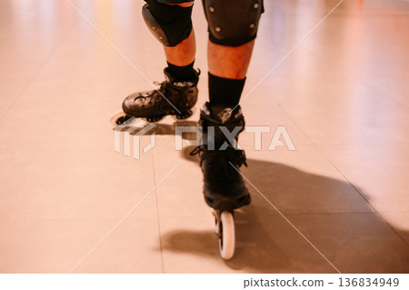 Active individual inline skating, wearing protective pads 136834949