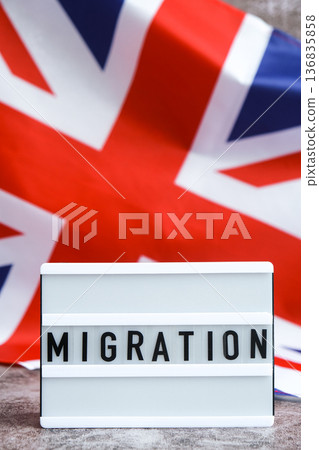 Lightbox with text MIGRATION flow. National symbol of Great Britain. British wave the UK silky flag background. Human migration crisis and population refugee movement. Demographic change Lightbox with text MIGRATION flow. National symbol of Great Britain. British wave the UK silky flag background. Human migration crisis and population refugee movement. Demographic change 136835858
