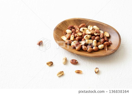 Roasted peanuts in a wooden plate Roasted peanuts in a wooden plate 136838164