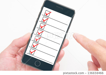 The hands of a person checking their smartphone screen The hands of a person checking their smartphone screen 136838466