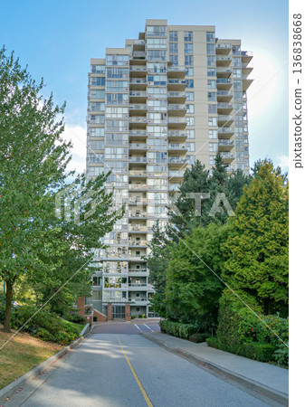 Asphalt driveway leading to a nice residential building 136838668