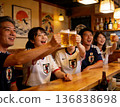 Soccer fans toasting at an izakaya 136838698