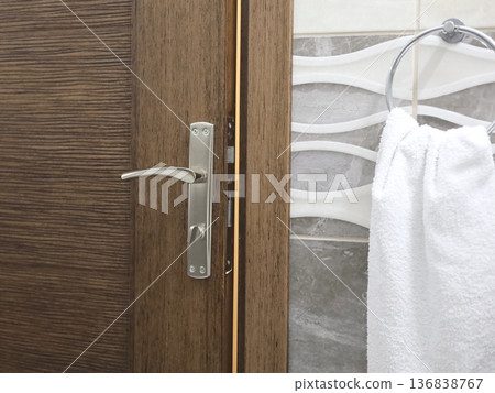 Wooden Door with Towel in Bathroom Wooden Door with Towel in Bathroom 136838767