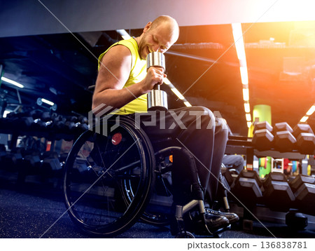 Disabled man training in the gym of rehabilitation center Disabled man training in the gym of rehabilitation center 136838781