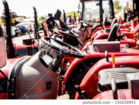 Rows of modern tractors. Industrial details. Agricultural Rows of modern tractors. Industrial details. Agricultural 136838941