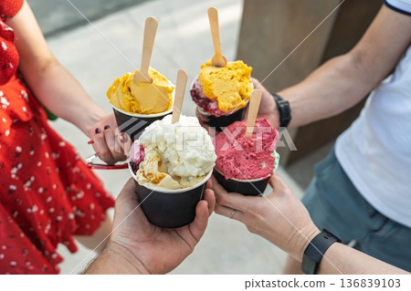 Celebrating Summer Friends Enjoying Colorful Gelato Treats Together in the Sunshine Celebrating Summer Friends Enjoying Colorful Gelato Treats Together in the Sunshine 136839103